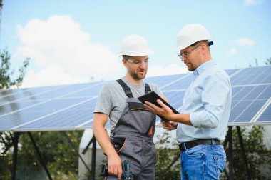 engineer and businessman planing new ecology project. around solar panel.