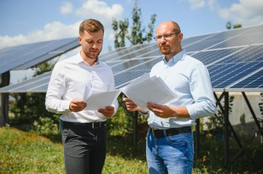 engineer and businessman planing new ecology project. around solar panel.