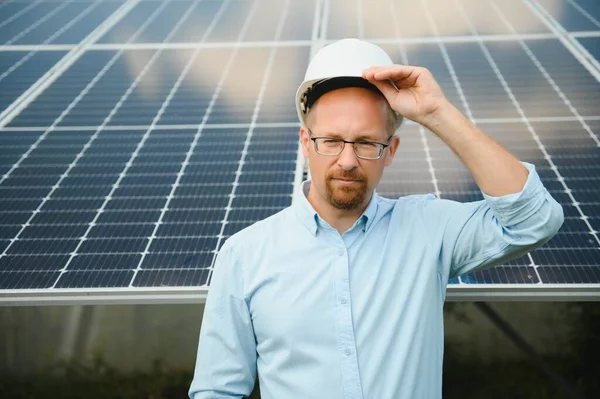 Solar energy. Young business man near the solar panels to power plants