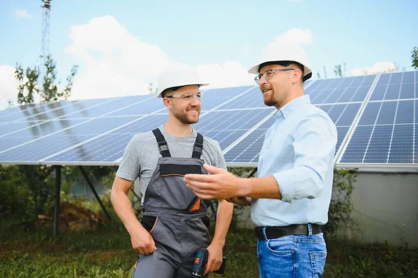 Worker installing solar panels outdoors.