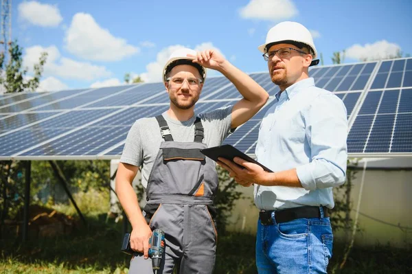 Worker installing solar panels outdoors.