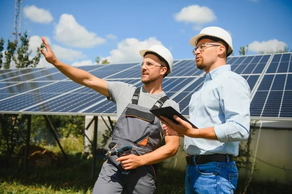 Worker installing solar panels outdoors.