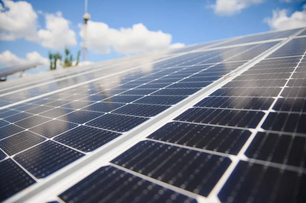 Worker installing solar panels outdoors.