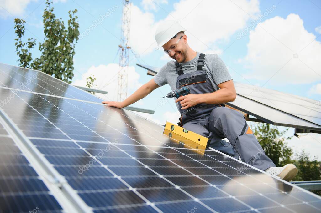 Worker installing solar panels outdoors.