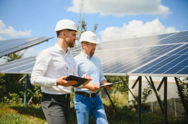 engineer and businessman planing new ecology project. around solar panel.