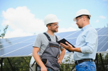 engineer and businessman planing new ecology project. around solar panel.