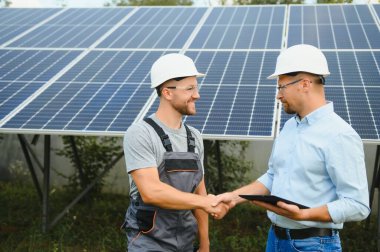 engineer and businessman planing new ecology project. around solar panel.