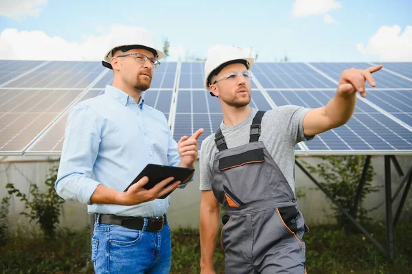 Worker installing solar panels outdoors.