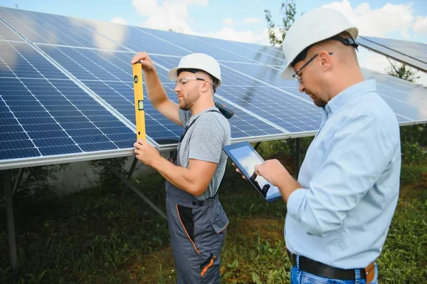 Solar panel. Technician installing solar panels on a sunny day.