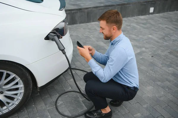 Hansome Bearded Guy Sitting His New Modern Electric Car Holding — Stock Photo, Image