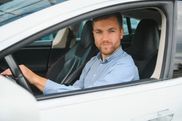 Businessman Holding Steering Wheel While Driving Modern Electric Car Street — Zdjęcie stockowe