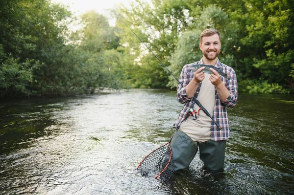 Fly Fisherman Holding Trout Out Water — Stockfoto