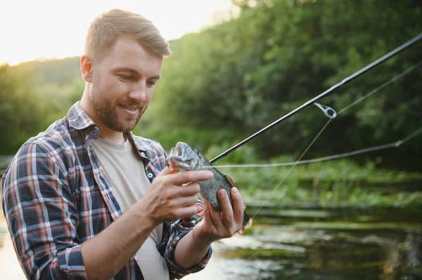 Fly Fisherman Holding Trout Out Water — Stockfoto
