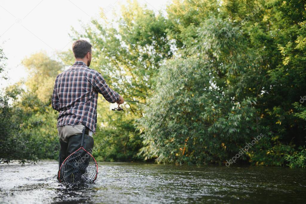 Trout fishing on mountain river.