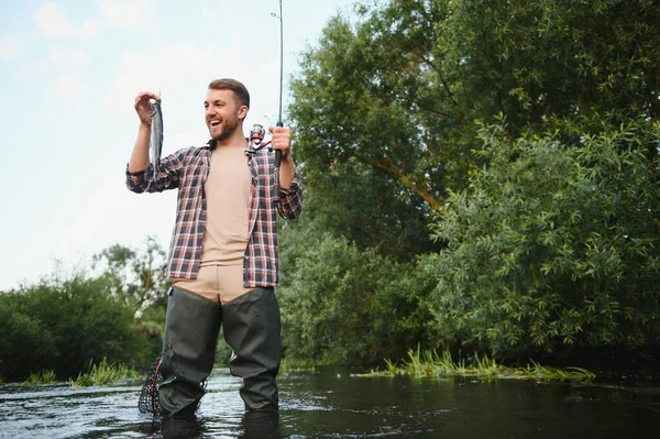 Fly Fisherman Holding Trout Out Water — Stockfoto