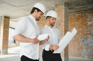Two civil engineers man inspecting construction.