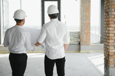 Two civil engineers man inspecting construction.