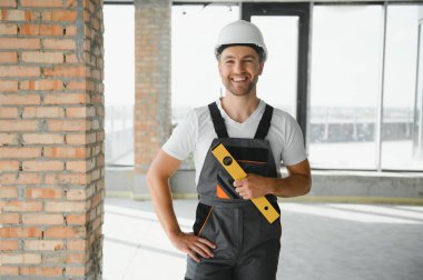profession, construction and building - male worker or builder in helmet