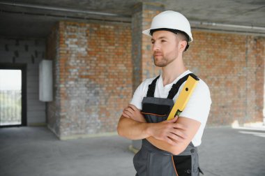 profession, construction and building - male worker or builder in helmet
