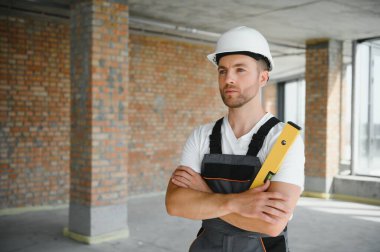 profession, construction and building - male worker or builder in helmet