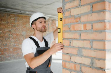 profession, construction and building - male worker or builder in helmet