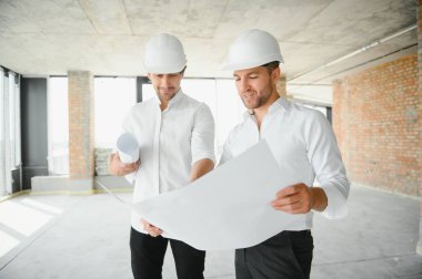 Two civil engineers man inspecting construction.
