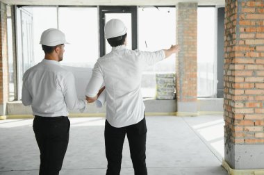 Two civil engineers man inspecting construction.