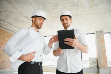 Two civil engineers man inspecting construction.