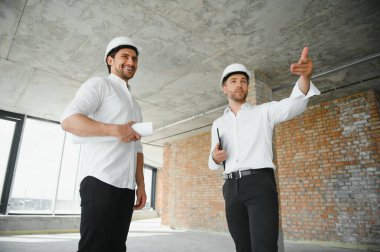 Two civil engineers man inspecting construction.