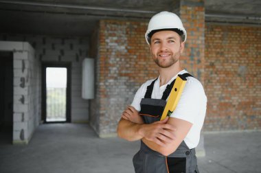 profession, construction and building - male worker or builder in helmet