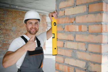 profession, construction and building - male worker or builder in helmet