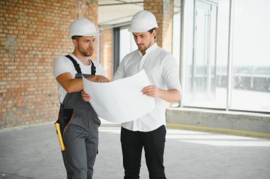 bir işçi ve bir inşaat hakkında bazı bilgileri izlerken mimar görünümü.