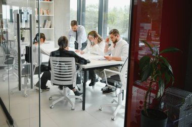 Ofiste proje üzerinde çalışan iş adamları.