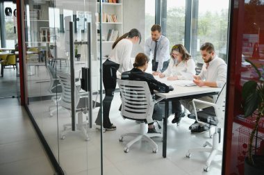 Corporate business team and manager in a meeting room at modern office with panoramic windows. Business concept.
