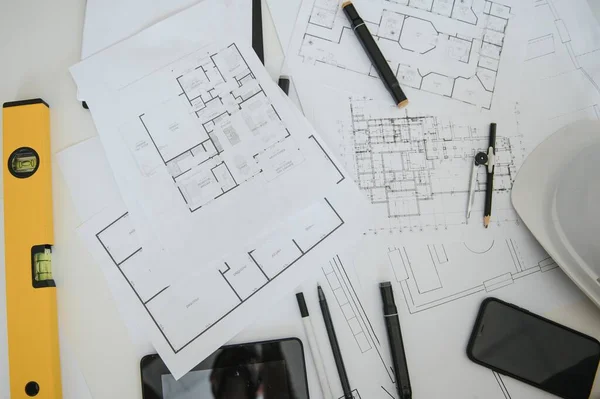 architect design working drawing sketch plans blueprints and making architectural construction model in architect studio,flat lay