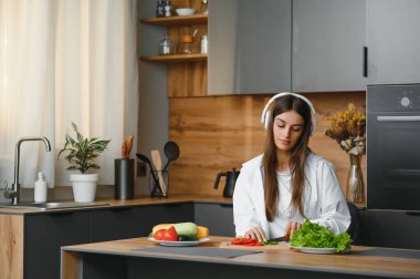 Güzel genç bayan mutfakta sebze salatası hazırlıyor. Sağlıklı yiyecekler. Vejetaryen salatası. Diyet olsun. Diyet Konsepti. Sağlıklı yaşam tarzı. Evde Pişirme