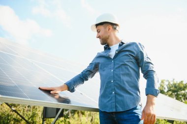 Solar power plant. Engineer on a background of photovoltaic panels. Science solar energy