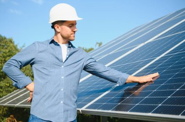 The solar farm(solar panel) with engineer check the operation of the system, Alternative energy to conserve the world's energy, Photovoltaic module idea for clean energy production.