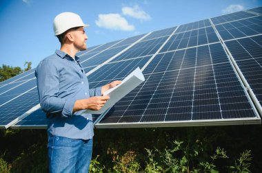 The solar farm(solar panel) with engineer check the operation of the system, Alternative energy to conserve the world's energy, Photovoltaic module idea for clean energy production.