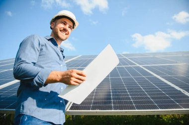 The solar farm(solar panel) with engineer check the operation of the system, Alternative energy to conserve the world's energy, Photovoltaic module idea for clean energy production.