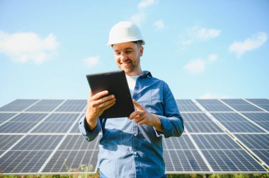 Solar power plant. Engineer on a background of photovoltaic panels. Science solar energy