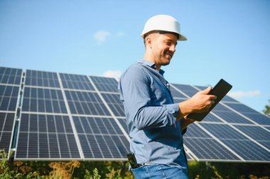 Solar power plant. Engineer on a background of photovoltaic panels. Science solar energy