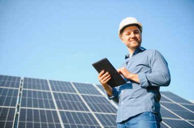 Solar power plant. Engineer on a background of photovoltaic panels. Science solar energy