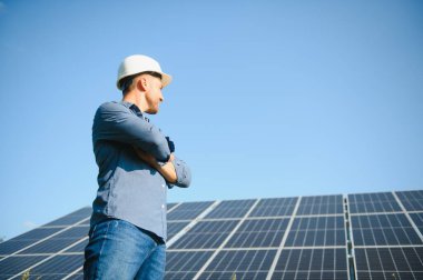 The solar farm(solar panel) with engineer check the operation of the system, Alternative energy to conserve the world's energy, Photovoltaic module idea for clean energy production.