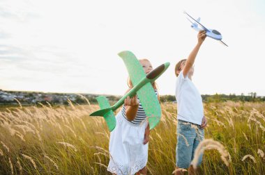 children play toy airplane. concept of happy childhood. children dream of flying and becoming a pilot