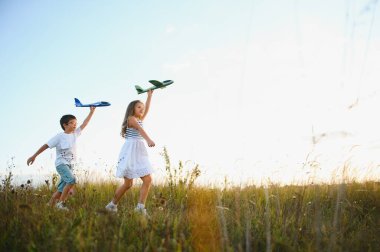 children play toy airplane. concept of happy childhood. children dream of flying and becoming a pilot