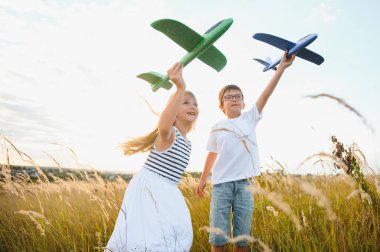 Active running kids with boy holding airplane toy