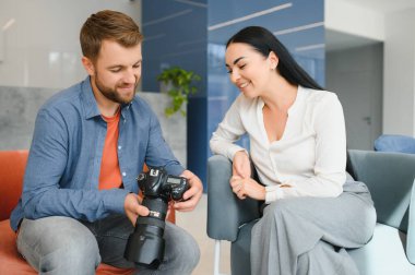 Photographer communicates with the client in the office