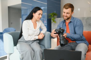 Photographer communicates with the client in the office