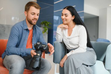 Photographer communicates with the client in the office
